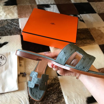 HERM Oran Slide Sandals In Vert Amande Ostrich Leather